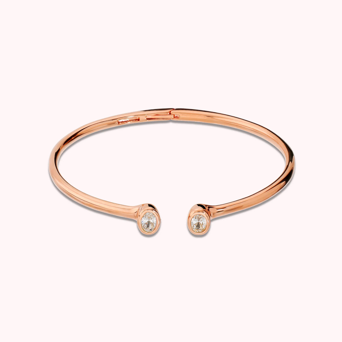 Hinged rigid bangle with double oval cubic zirconia, plated with 18Kt gold