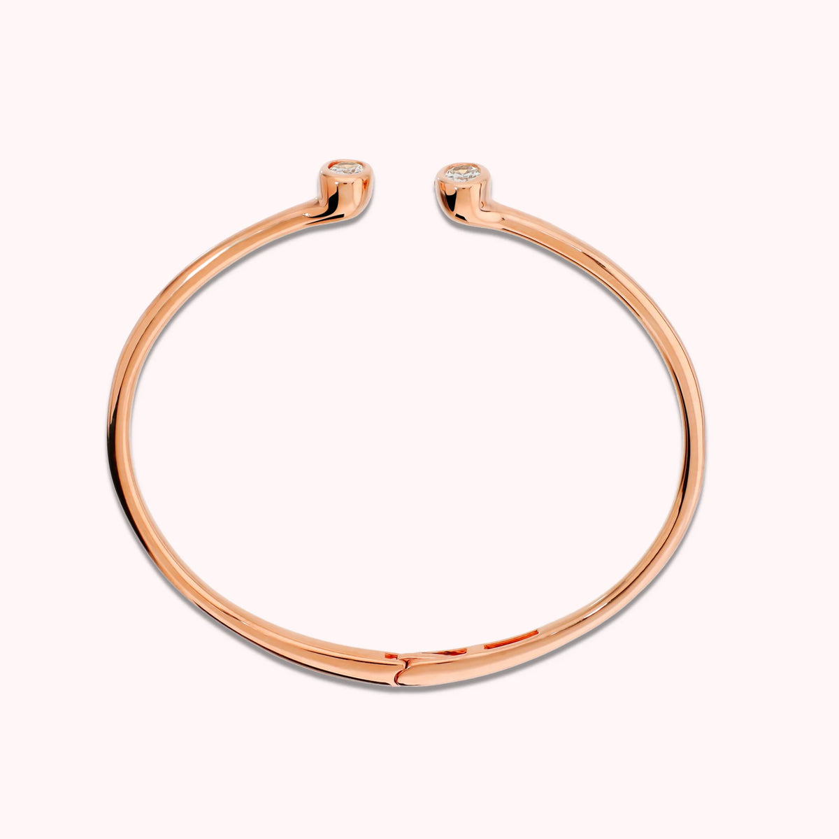 Hinged rigid bangle with double oval cubic zirconia, plated with 18Kt gold