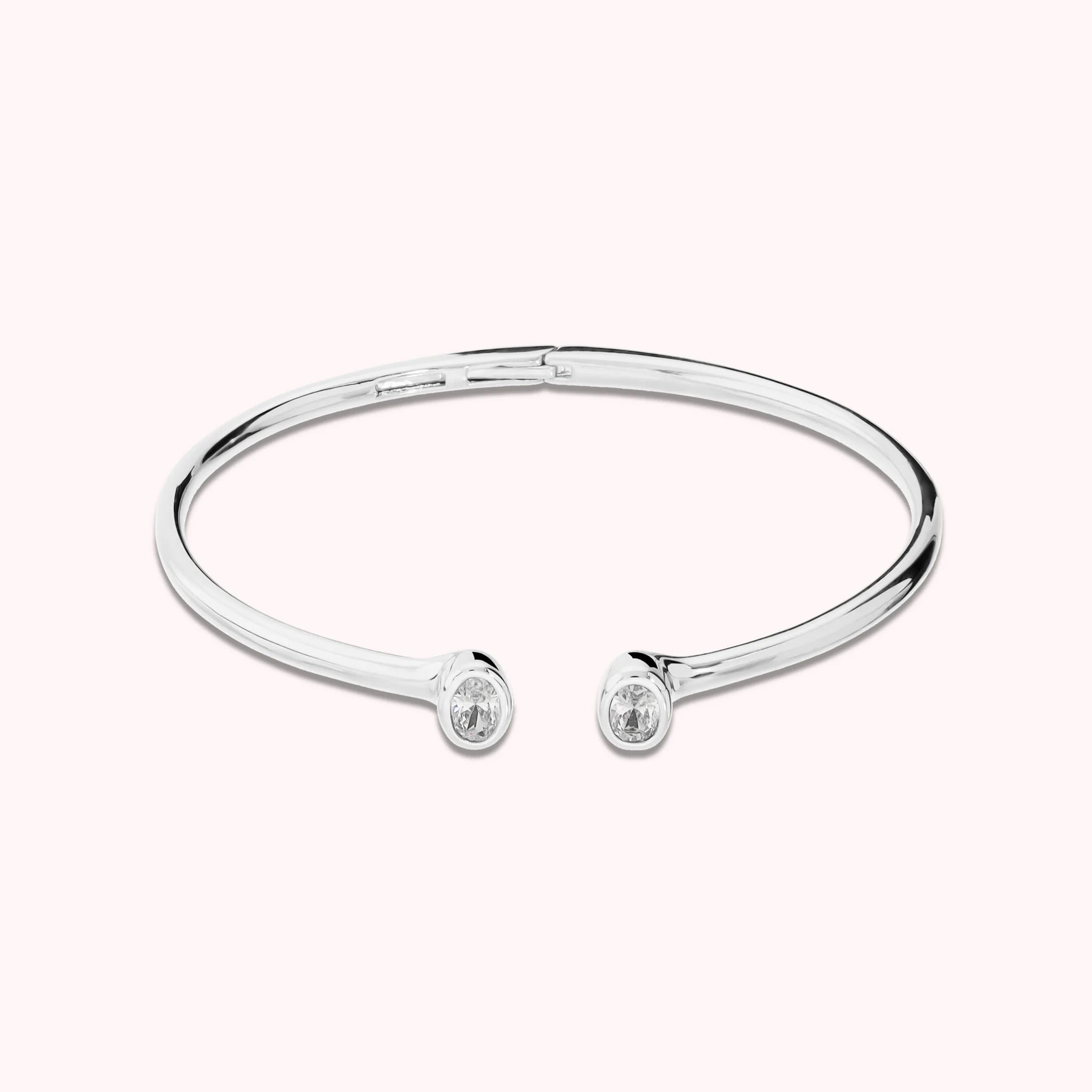 Hinged rigid bangle with double oval cubic zirconia, plated with 18Kt gold