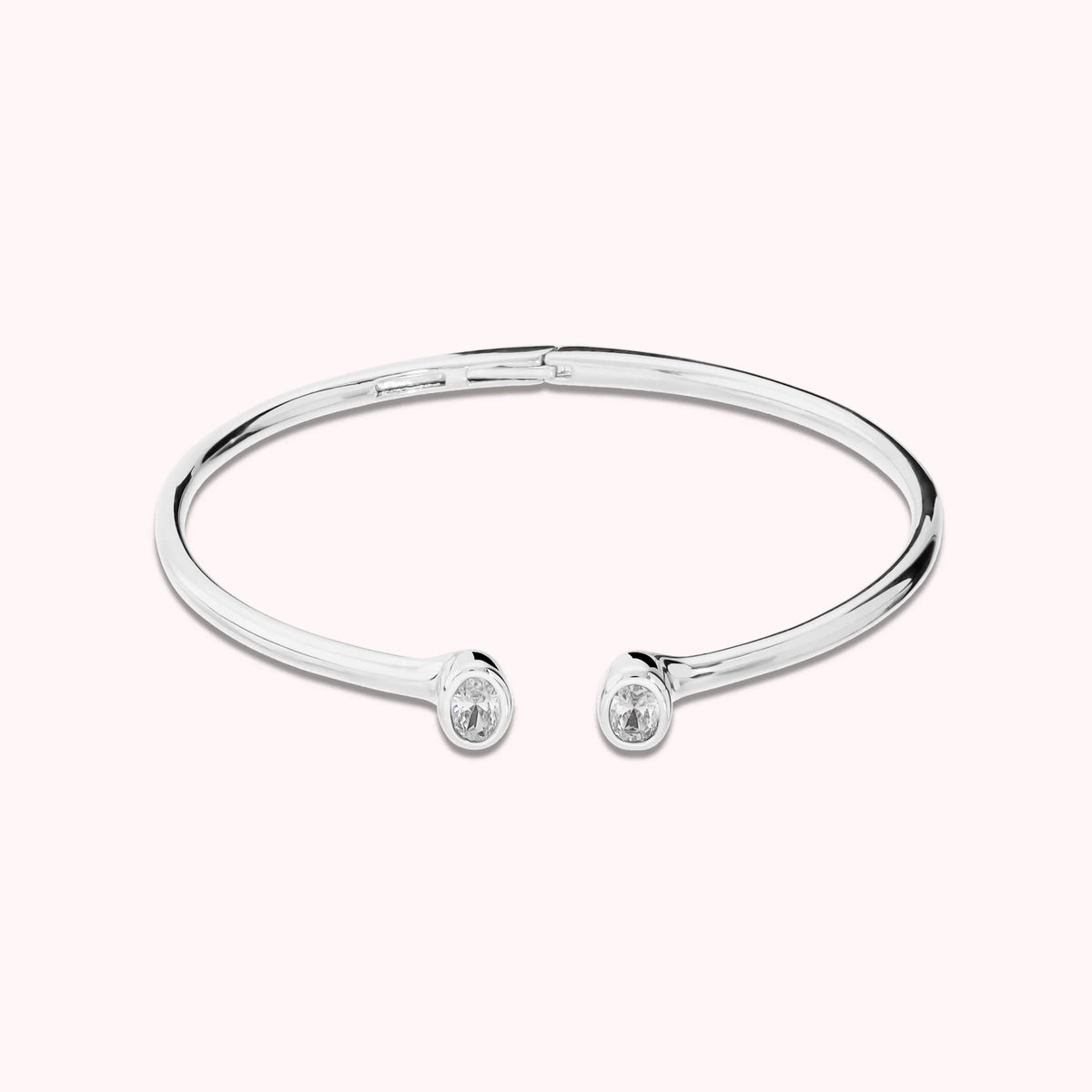Hinged rigid bangle with double oval cubic zirconia, plated with 18Kt gold