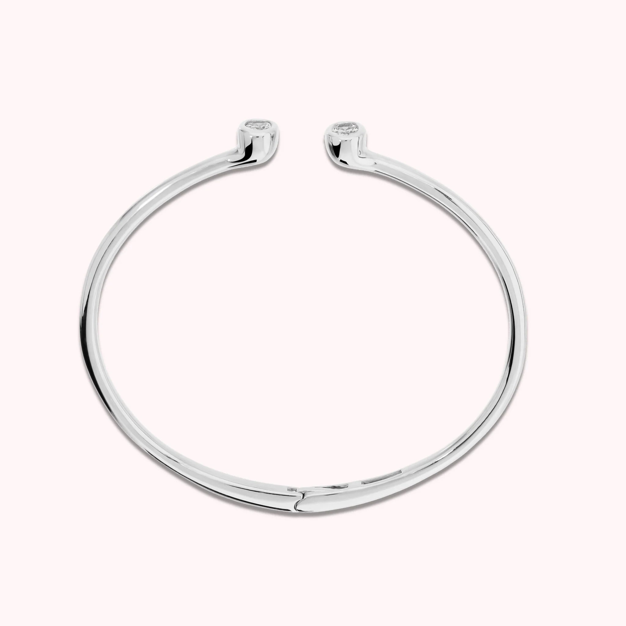 Hinged rigid bangle with double oval cubic zirconia, plated with 18Kt gold