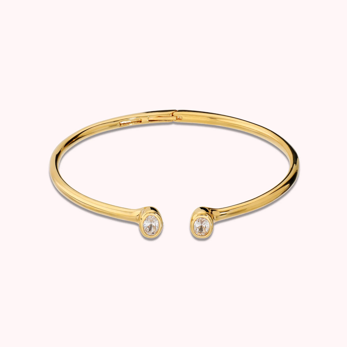 Hinged rigid bangle with double oval cubic zirconia, plated with 18Kt gold
