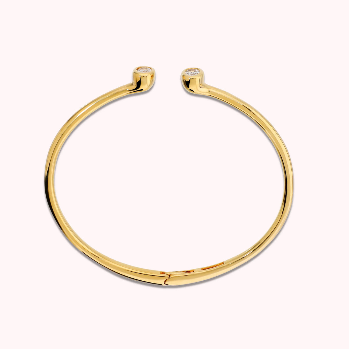 Hinged rigid bangle with double oval cubic zirconia, plated with 18Kt gold